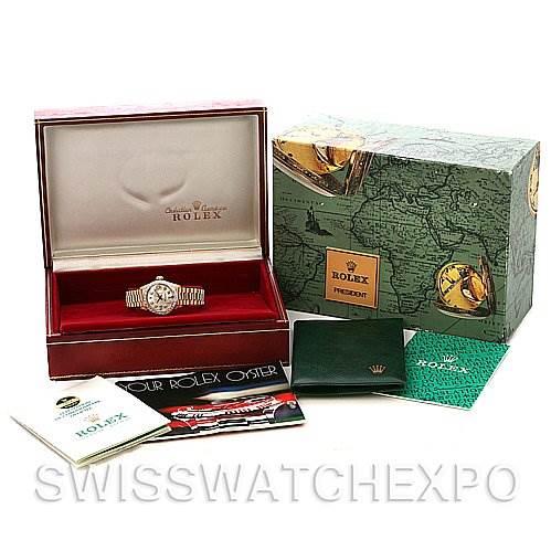 The image shows a Rolex President 6917 Women's Yellow Gold  6917 Women's Yellow Gold  watch at a front angle in its box, along with its original packaging, manuals, and booklets.