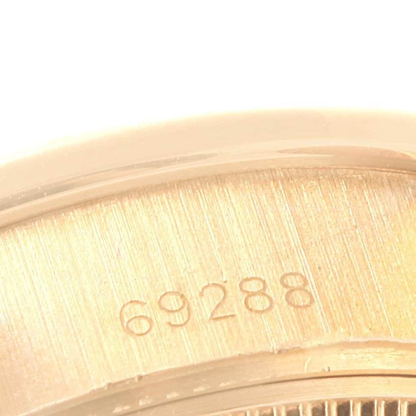 A close-up angle showing the model number engraving on the gold case of a Rolex President 69288 Women
s Yellow Gold Champagne Dial 69288 Women
s Yellow Gold Champagne Dial watch, model 69288.