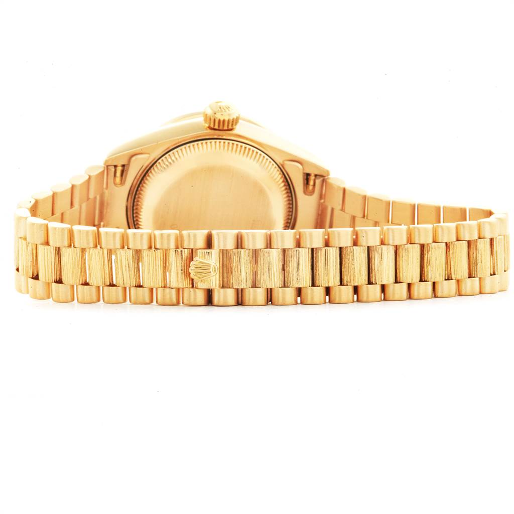 The image shows the rear view of a Rolex President 69288 Women
s Yellow Gold Champagne Dial 69288 Women
s Yellow Gold Champagne Dial model watch, focusing on the case back and the bracelet.