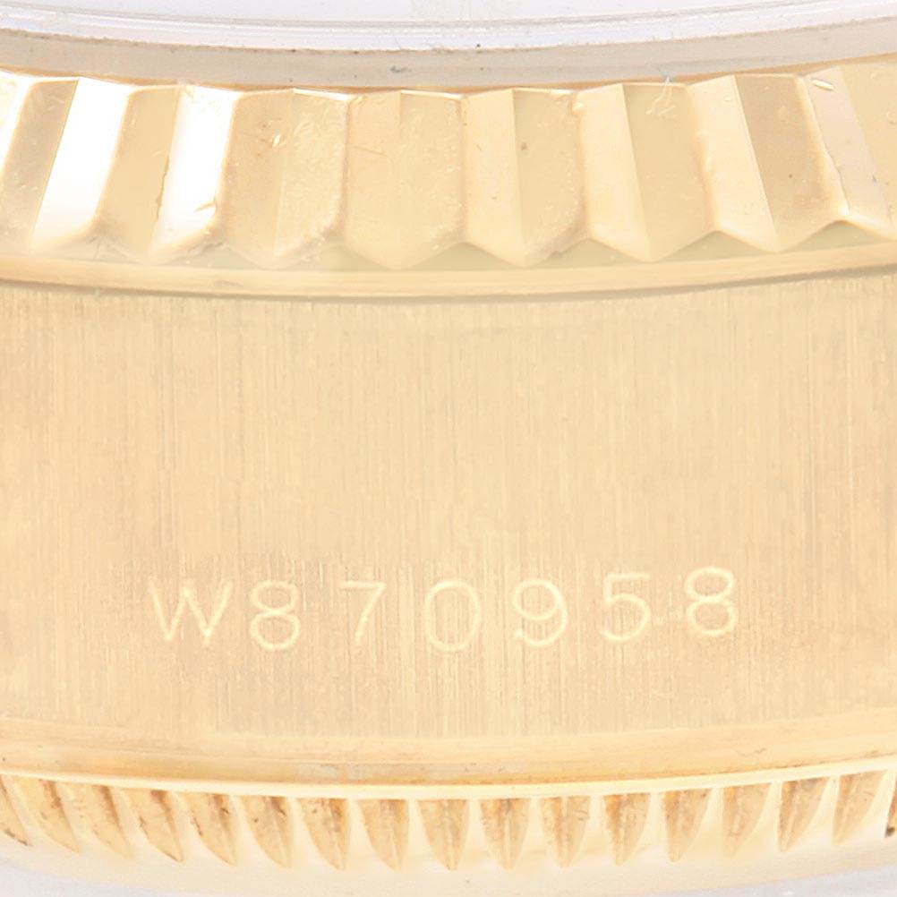 This close-up image shows the serial number between the lugs and part of the fluted bezel of a Rolex President 69178 Women
s Yellow Gold Champagne Dial 69178 Women
s Yellow Gold Champagne Dial model watch.