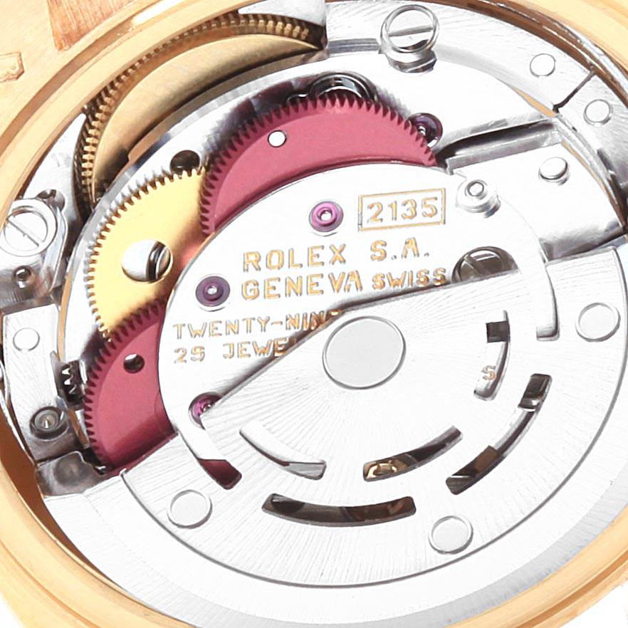 The close-up image shows the internal movement mechanism of a Rolex President 69178 Women
s Yellow Gold Champagne Dial 69178 Women
s Yellow Gold Champagne Dial model watch, including gears and engravings.