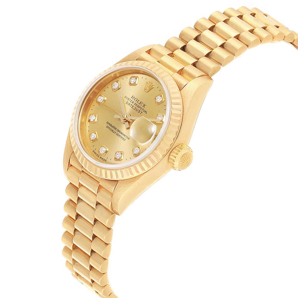 The image shows a side angle of a gold Rolex President 69178 Women
s Yellow Gold Champagne Dial 69178 Women
s Yellow Gold Champagne Dial model watch with a fluted bezel and diamond markers.