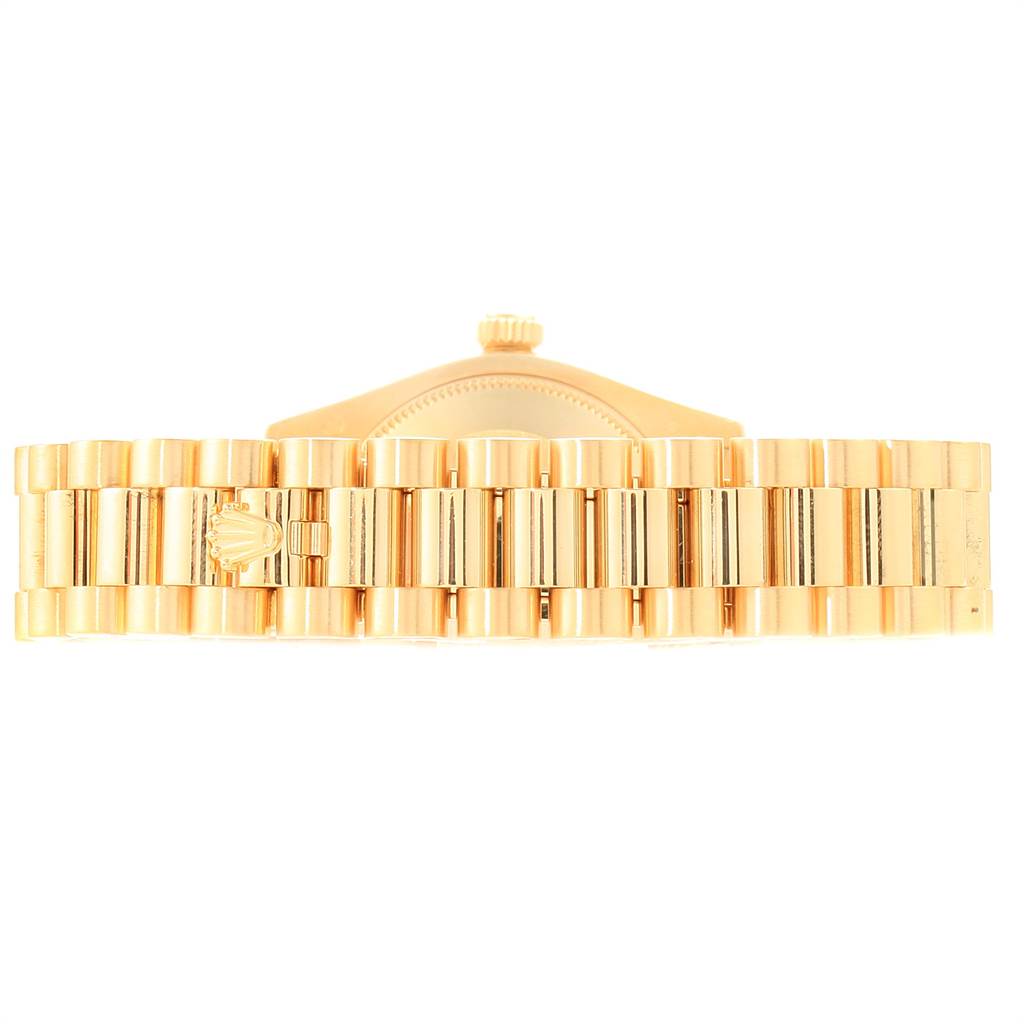 The image shows the gold bracelet and part of the crown of a Rolex President 178288 Women
s Yellow Gold Champagne Dial 178288 Women
s Yellow Gold Champagne Dial model watch from a top view.