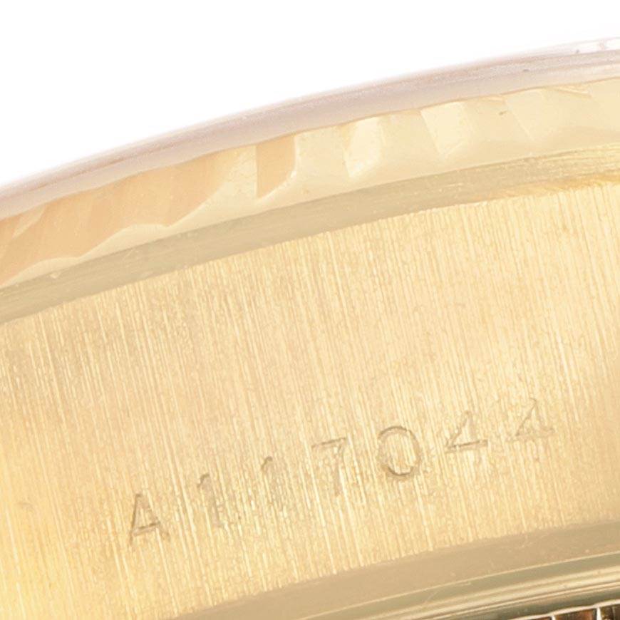 The image shows a close-up of the side of the Rolex President 79178 Women
s Yellow Gold Mother of Pearl Dial 79178 Women
s Yellow Gold Mother of Pearl Dial model, highlighting the bezel and part of the case with a serial number.