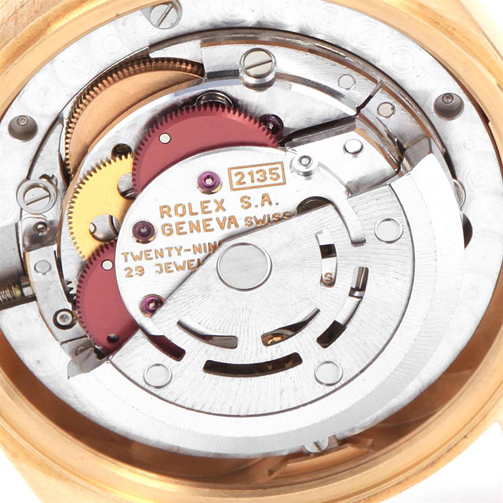 The image shows the intricate internal mechanism of a Rolex President 68278 Women
s Yellow Gold Champagne Dial 68278 Women
s Yellow Gold Champagne Dial model watch from a straight-on angle.