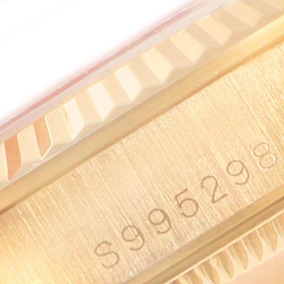 This image shows a close-up of the case and bezel of the Rolex President 68278 Women
s Yellow Gold Champagne Dial 68278 Women
s Yellow Gold Champagne Dial model watch with a visible serial number.