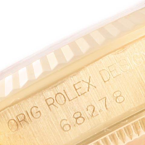 The image shows a close-up of the engraved serial number and fluted bezel of a Rolex President 68278 Women
s Yellow Gold Champagne Dial 68278 Women
s Yellow Gold Champagne Dial model watch.