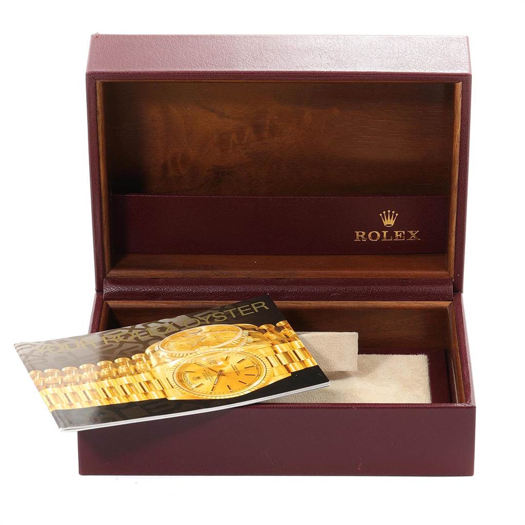 This image shows an open Rolex watch box for the President model, with a booklet inside while the watch is absent.