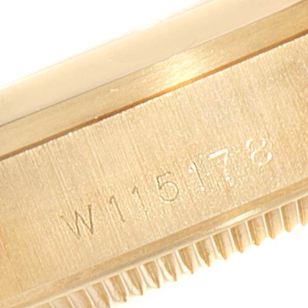 This close-up image shows the side of a Rolex President 68278 Women's Yellow Gold Beige Dial 68278 Women's Yellow Gold Beige Dial watch with a serial number engraved on the case.