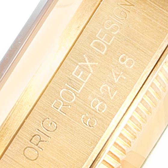 The image shows a close-up angle of the engraved side of a Rolex President 68278 Women's Yellow Gold Beige Dial 68278 Women's Yellow Gold Beige Dial watch, highlighting the design and model number.