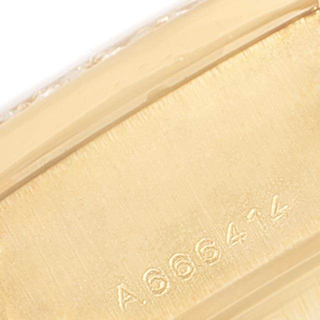 This close-up image shows the serial number engraving on the case of a Rolex President 79158 Women's Yellow Gold Silver Dial 79158 Women's Yellow Gold Silver Dial model watch.