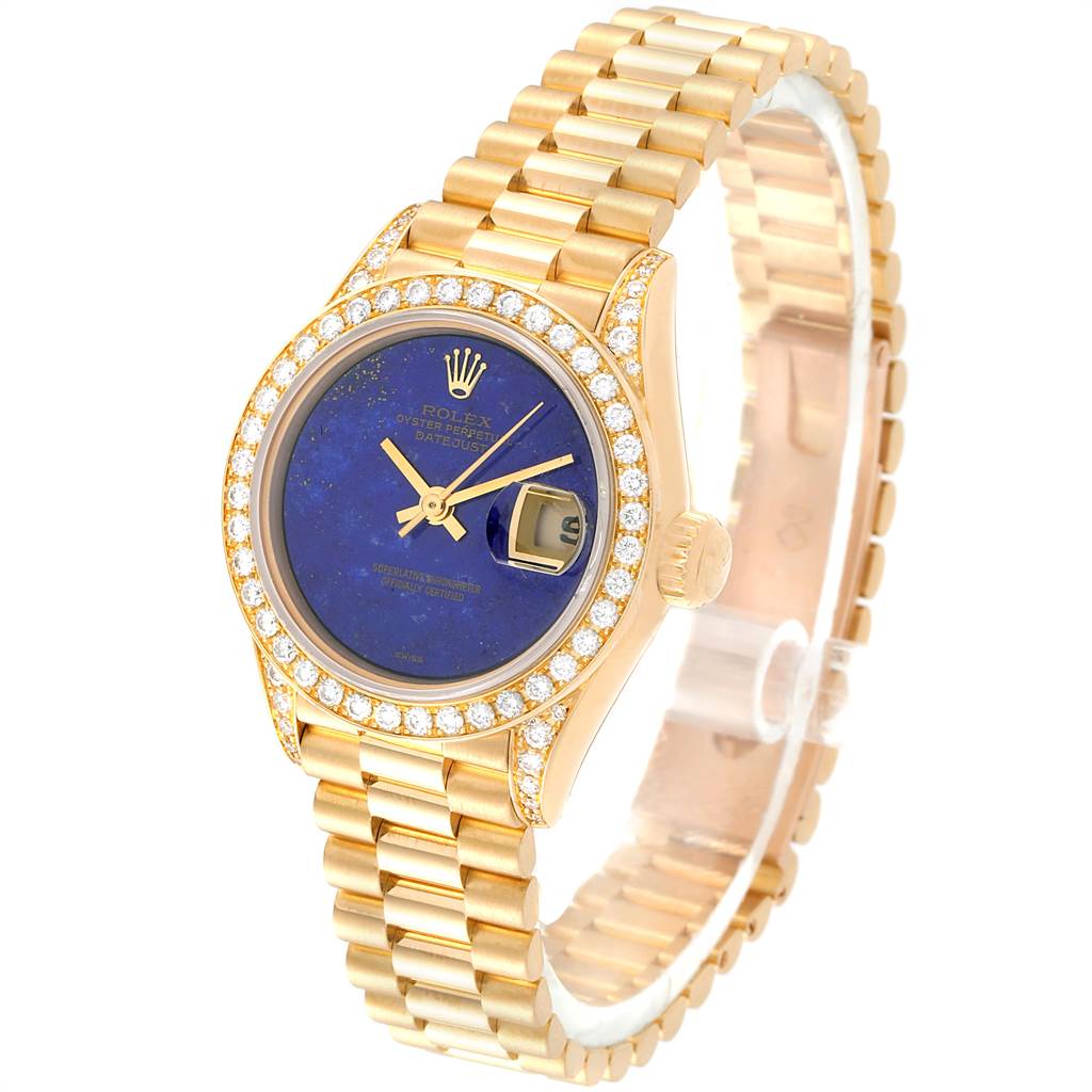 The Rolex President 69158 Women's Yellow Gold Blue Dial 69158 Women's Yellow Gold Blue Dial model is shown at a three-quarter angle, displaying its gold bracelet, blue dial, date window, and diamond-studded bezel.