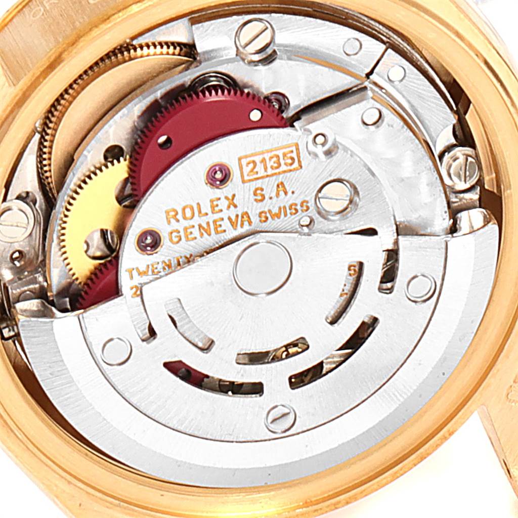 The image shows the internal mechanism of a Rolex President 69178 Women
s Yellow Gold White Dial 69178 Women
s Yellow Gold White Dial model watch, highlighting the movement and intricate gears.