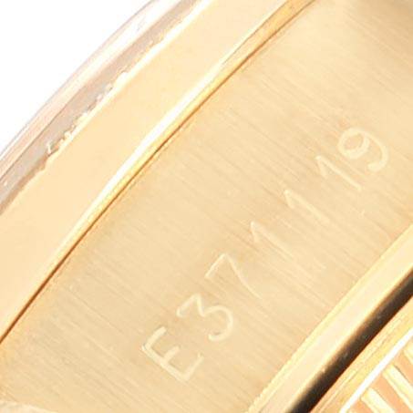 This close-up shows part of the gold case with the serial number engraved on a Rolex President 69288 Women's Yellow Gold Beige Dial 69288 Women's Yellow Gold Beige Dial model watch.