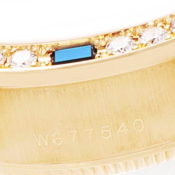 The image shows a close-up of the bezel and case of a Rolex President 69088 Women's Yellow Gold Mother of Pearl Dial 69088 Women's Yellow Gold Mother of Pearl Dial model watch, featuring diamonds and an engraved serial number.
