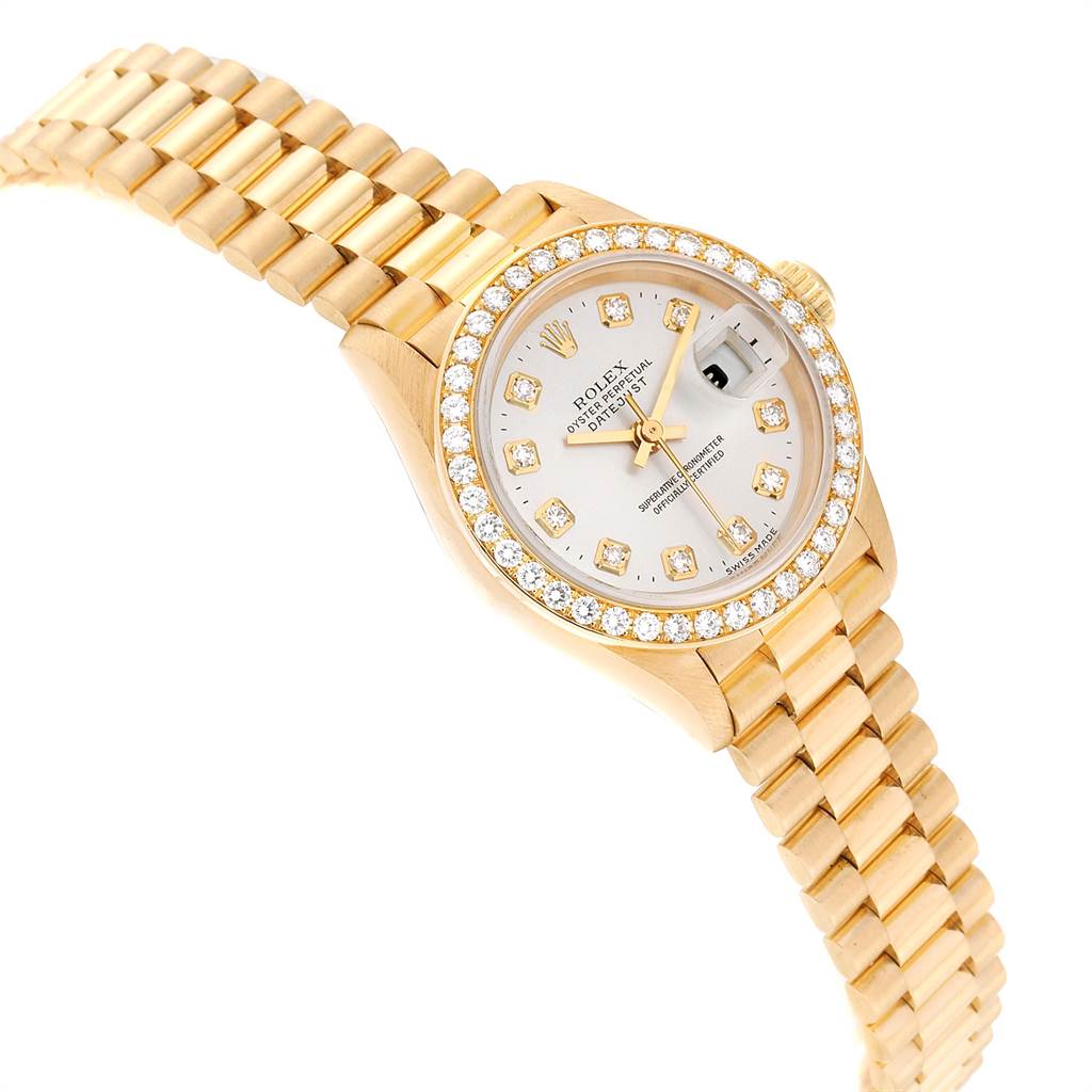 This image shows a Rolex President 69138 Women's Yellow Gold Silver Dial 69138 Women's Yellow Gold Silver Dial model watch at a slight right-side angle, displaying its gold bracelet, diamond bezel, and dial.