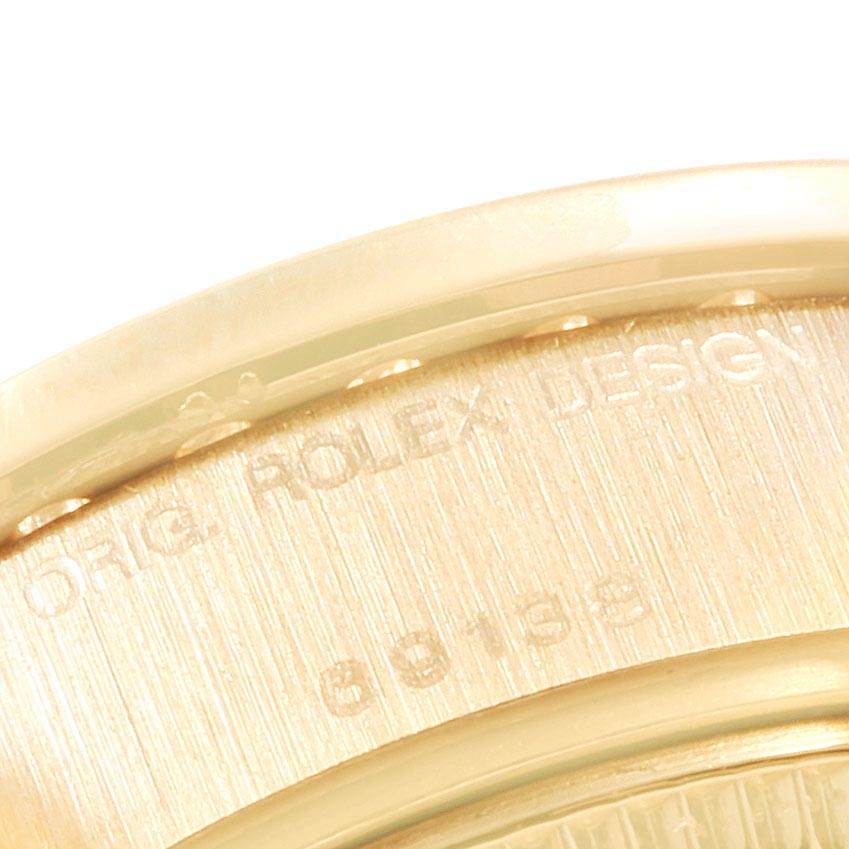 This is a close-up of the side view of the Rolex President 69138 Women's Yellow Gold Silver Dial 69138 Women's Yellow Gold Silver Dial model, focusing on the engraved text and serial number.