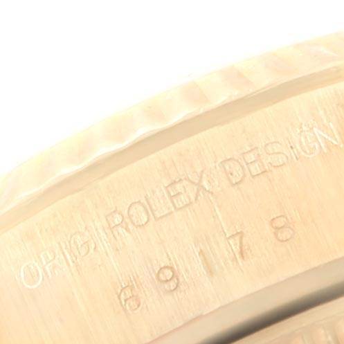 This close-up image shows the engraved bezel and part of the case of the Rolex President 69178 Women's Yellow Gold Silver Dial 69178 Women's Yellow Gold Silver Dial model watch.