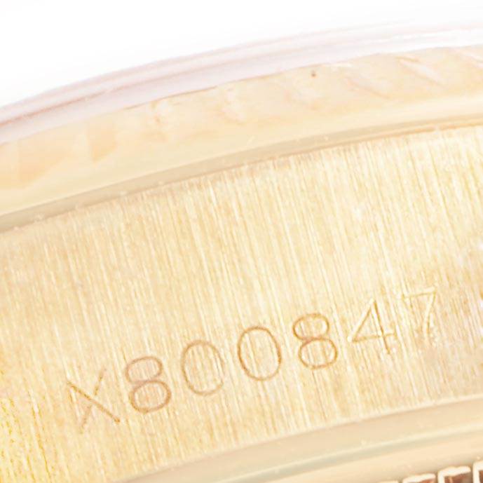 This close-up angle shows the serial number engraving on the case of the Rolex President 69178 Women's Yellow Gold Silver Dial 69178 Women's Yellow Gold Silver Dial model watch.