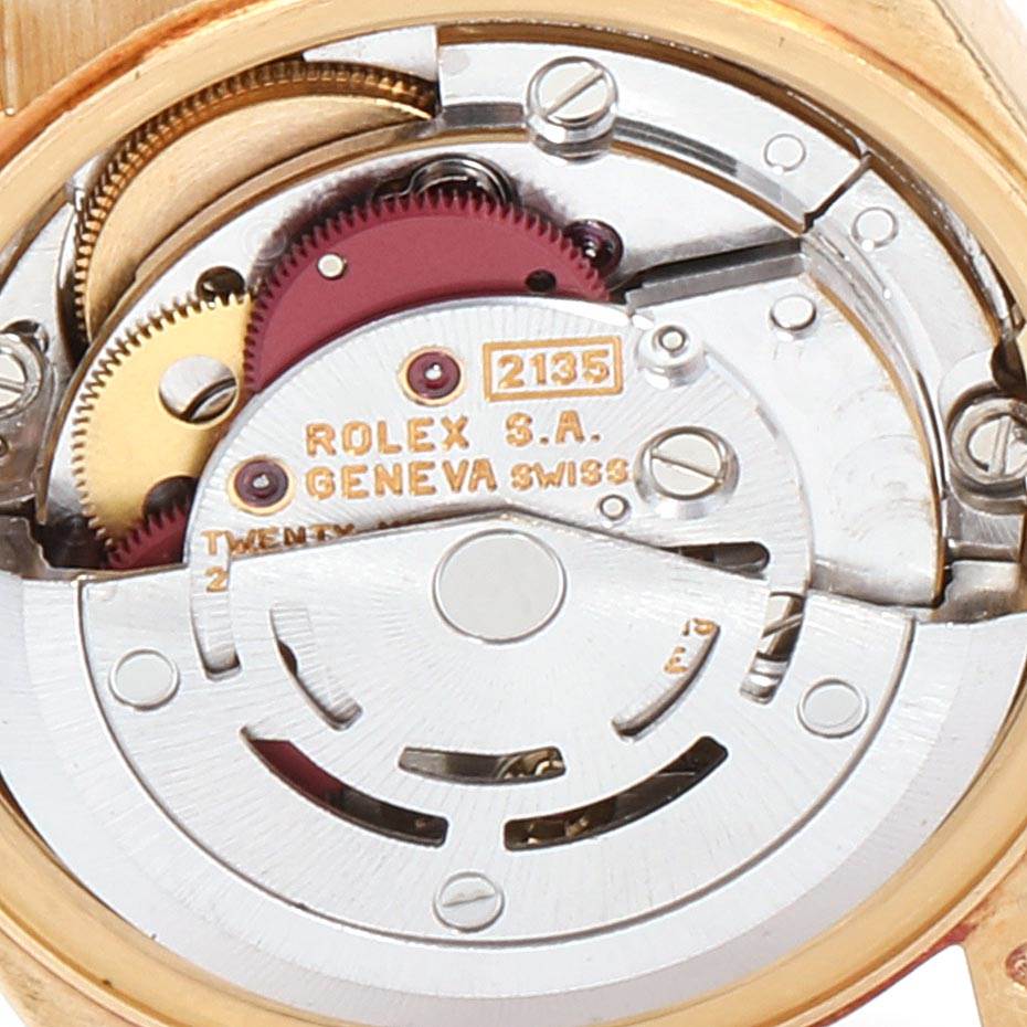 This image shows a close-up of the internal movement mechanism of a Rolex President 69178 Women's Yellow Gold Silver Dial 69178 Women's Yellow Gold Silver Dial model watch, highlighting the gears and inscription details.