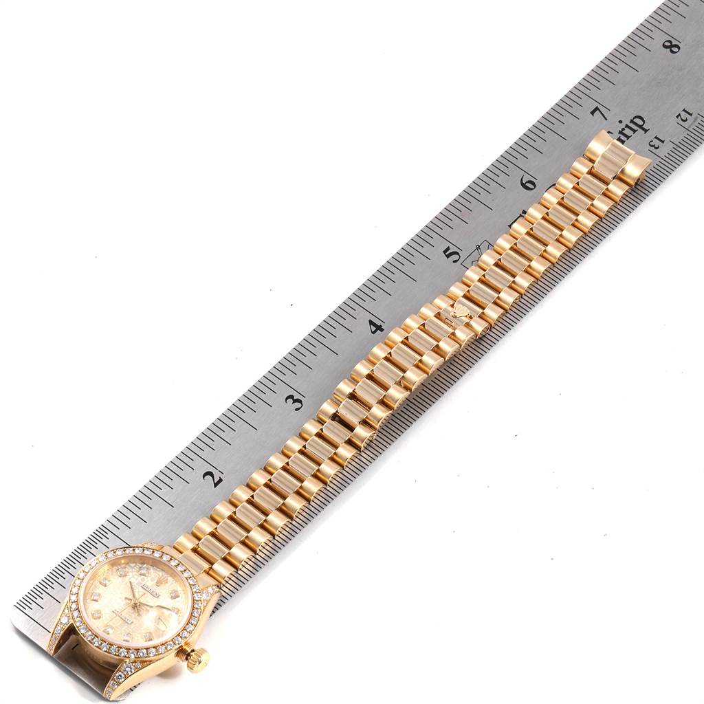 The Rolex President 179298 Women
s Yellow Gold Champagne Dial 179298 Women
s Yellow Gold Champagne Dial watch is shown from a top-down angle, displaying its face, bezel, and full bracelet in gold.