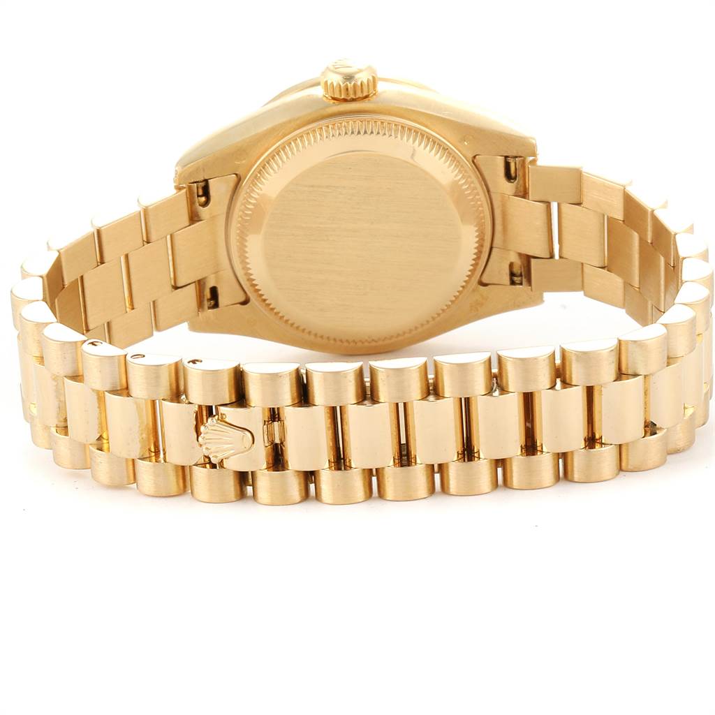 The image shows the rear view of a Rolex President 179298 Women
s Yellow Gold Champagne Dial 179298 Women
s Yellow Gold Champagne Dial model watch, highlighting the case back and gold bracelet.