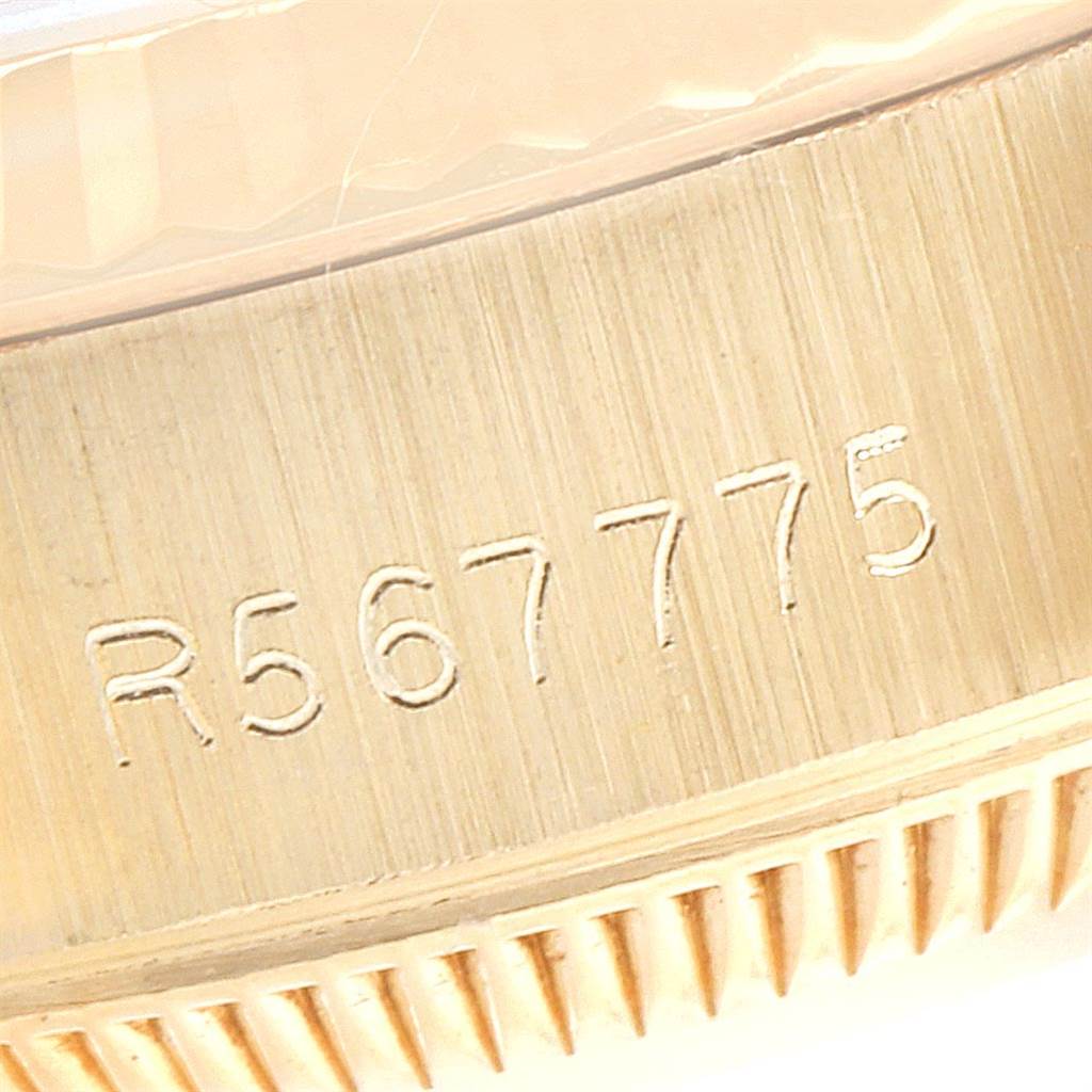 This image of the Rolex President 69178 Women
s Yellow Gold Champagne Dial 69178 Women
s Yellow Gold Champagne Dial watch shows a close-up view of the bezel and part number engravings.