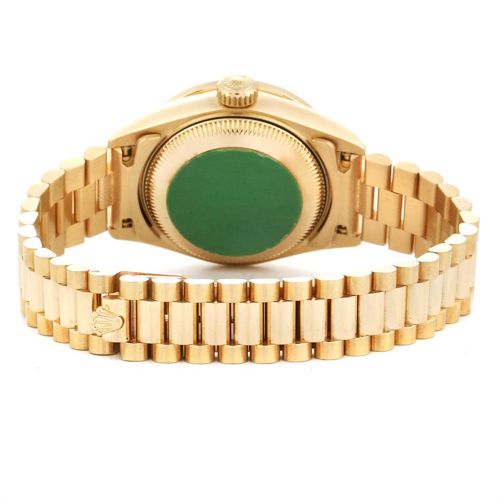 The image shows the Rolex President 69138 Women's Yellow Gold Green Dial 69138 Women's Yellow Gold Green Dial model watch's gold bracelet and the back of its case from a rear angle.