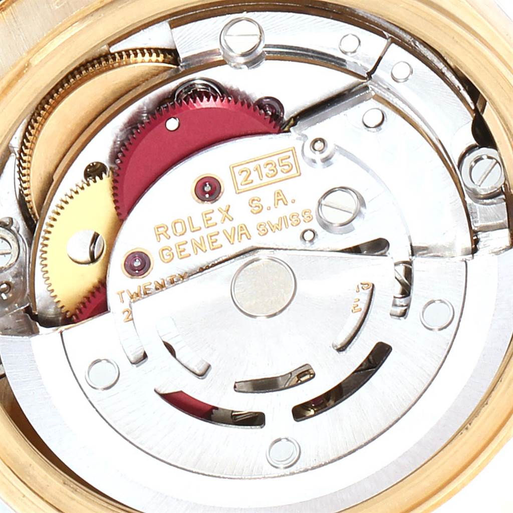 This image shows an internal view of the Rolex President 69138 Women's Yellow Gold Green Dial 69138 Women's Yellow Gold Green Dial model's movement, specifically parts of its gears and mechanisms.