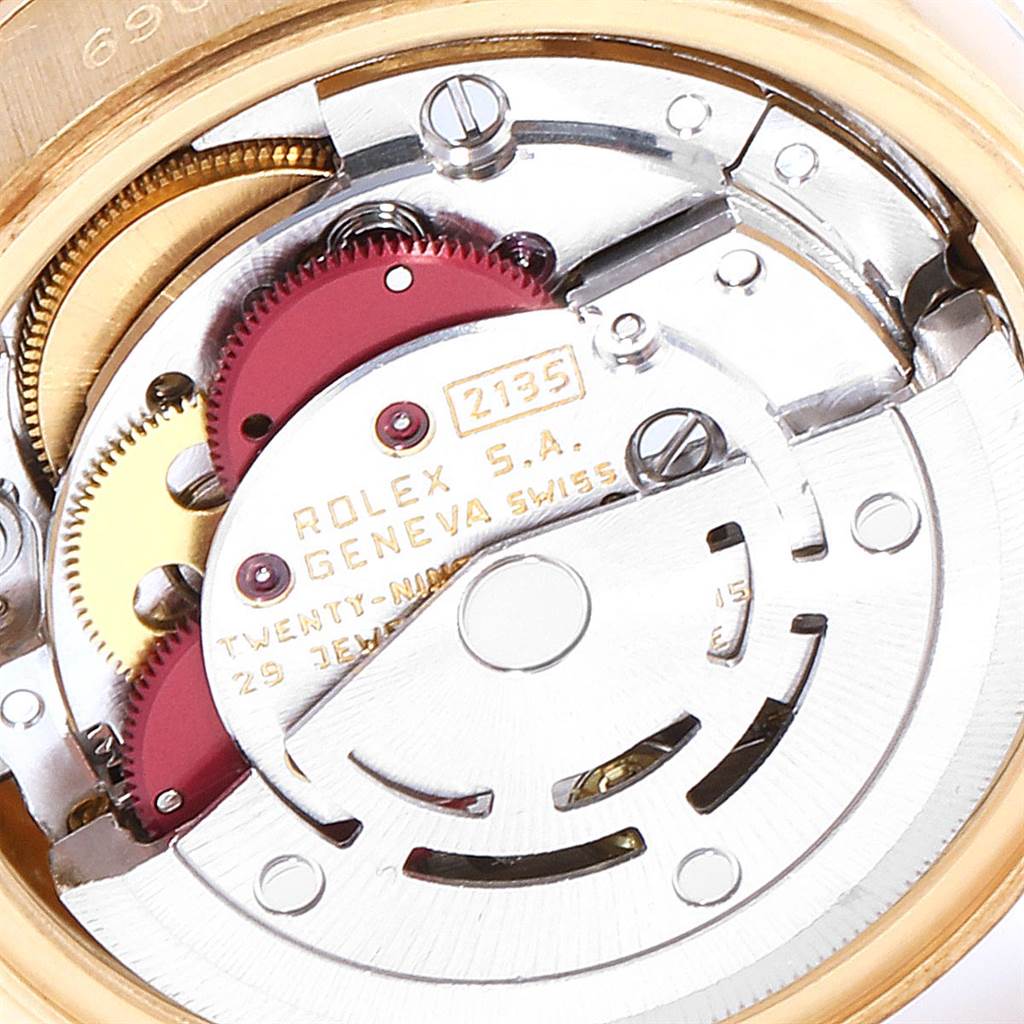 This image shows the intricate inner mechanism of a Rolex President 69088 Women's Yellow Gold Blue Dial 69088 Women's Yellow Gold Blue Dial model watch, highlighting gears and movement components.