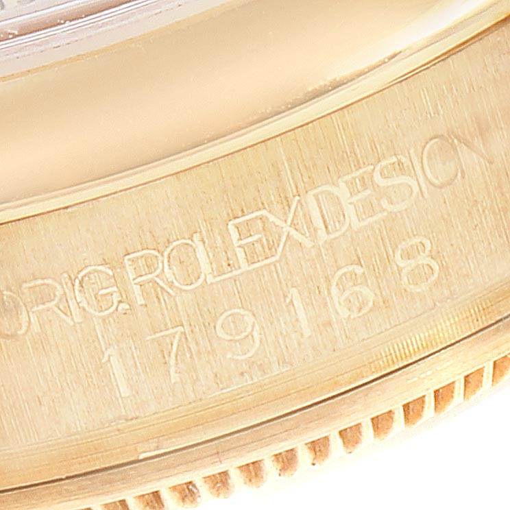 This close-up image shows the side of a Rolex President 179168 Women
s Yellow Gold Champagne Dial 179168 Women
s Yellow Gold Champagne Dial watch case, highlighting the engraved model and serial numbers.