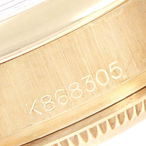 The image shows a close-up of the Rolex President 179168 Women
s Yellow Gold Champagne Dial 179168 Women
s Yellow Gold Champagne Dial model watch
s outer case with engraved serial number K868305.