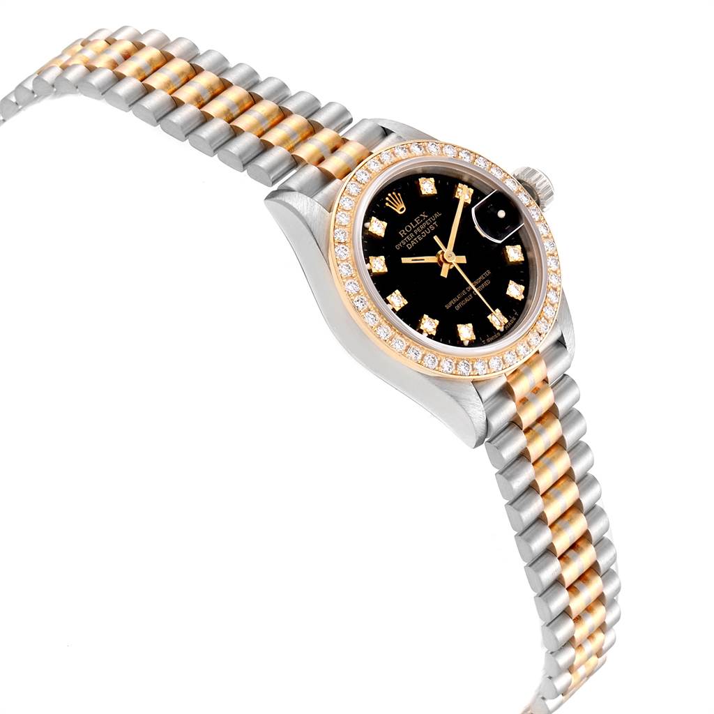 The image shows a Rolex President 69179 Women's White Gold Black Dial 69179 Women's White Gold Black Dial model watch at an angle highlighting its gold and silver bracelet, diamond bezel, and black dial.
