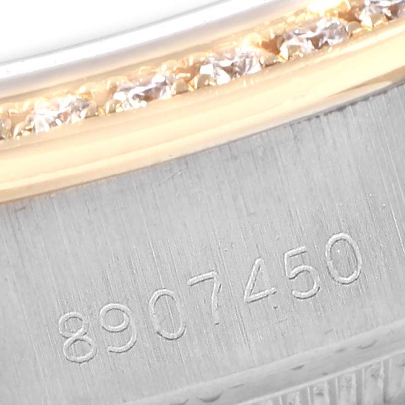 This is a close-up view of the Rolex President 69179 Women's White Gold Black Dial 69179 Women's White Gold Black Dial watch showing its bezel with diamonds and a partial serial number engraving.