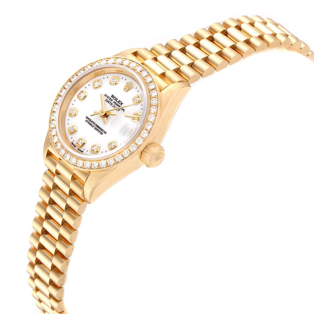 This image shows a Rolex President 69138 Women
s Yellow Gold White Dial 69138 Women
s Yellow Gold White Dial model watch at a side angle, highlighting its gold band, jeweled bezel, and white dial.