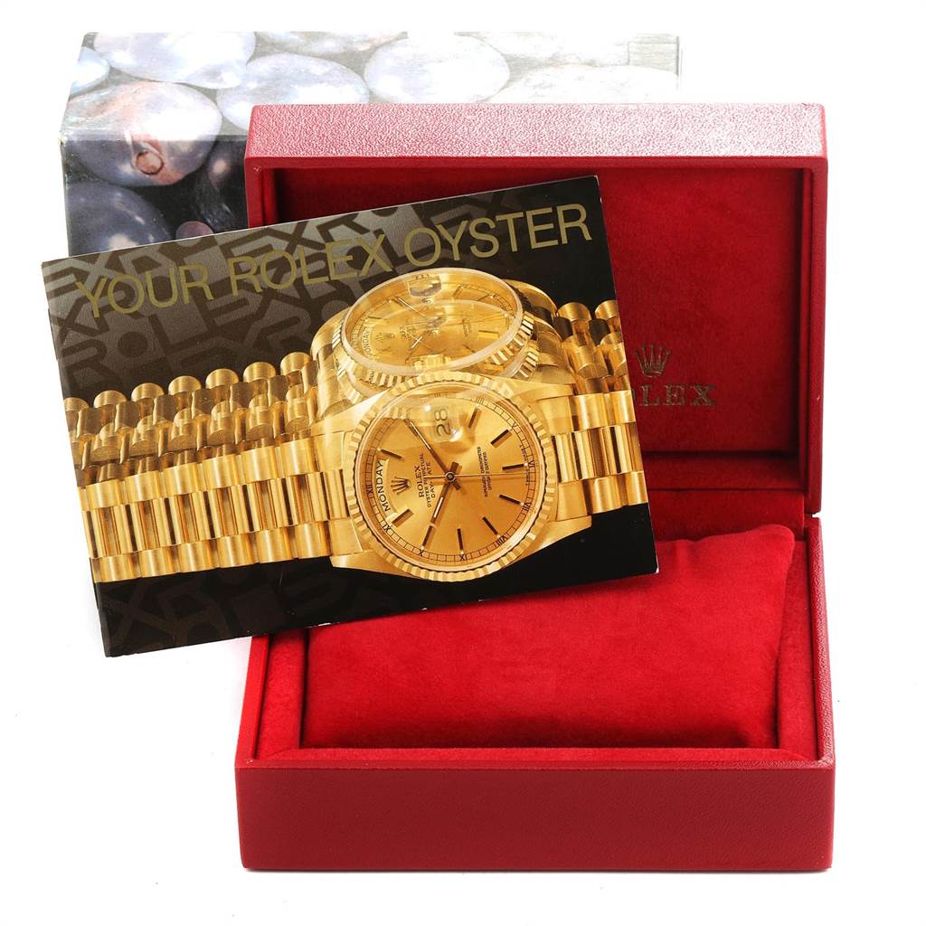 The image shows a Rolex President 69138 Women
s Yellow Gold White Dial 69138 Women
s Yellow Gold White Dial model watch manual inside an open red Rolex box.