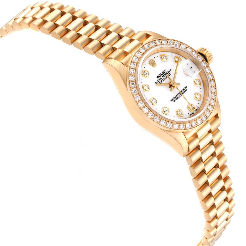 The Rolex President 69138 Women
s Yellow Gold White Dial 69138 Women
s Yellow Gold White Dial model watch is shown at an angle that highlights its gold bracelet, diamond-encrusted bezel, and white dial.