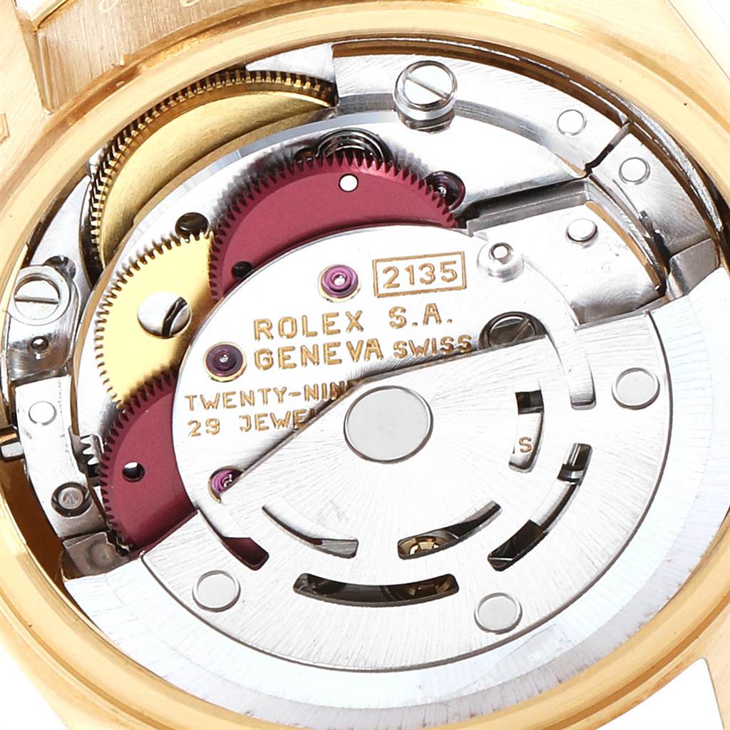 A close-up of the internal movement mechanism of a Rolex President 69258 Women
s Yellow Gold Champagne Dial 69258 Women
s Yellow Gold Champagne Dial model watch, showcasing its intricate gears and components.
