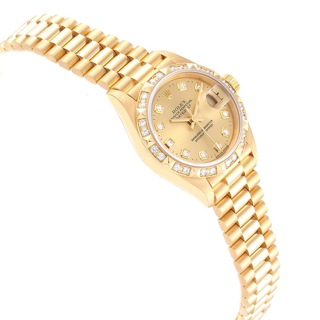 This image shows a Rolex President 69258 Women
s Yellow Gold Champagne Dial 69258 Women
s Yellow Gold Champagne Dial model watch from an angled view, highlighting the gold bracelet, diamond bezel, and dial.