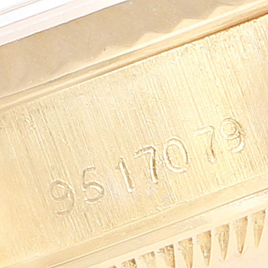 This close-up image shows the serial number engraving on the gold case of a Rolex President 69178 Women's Yellow Gold Silver Dial 69178 Women's Yellow Gold Silver Dial model watch.