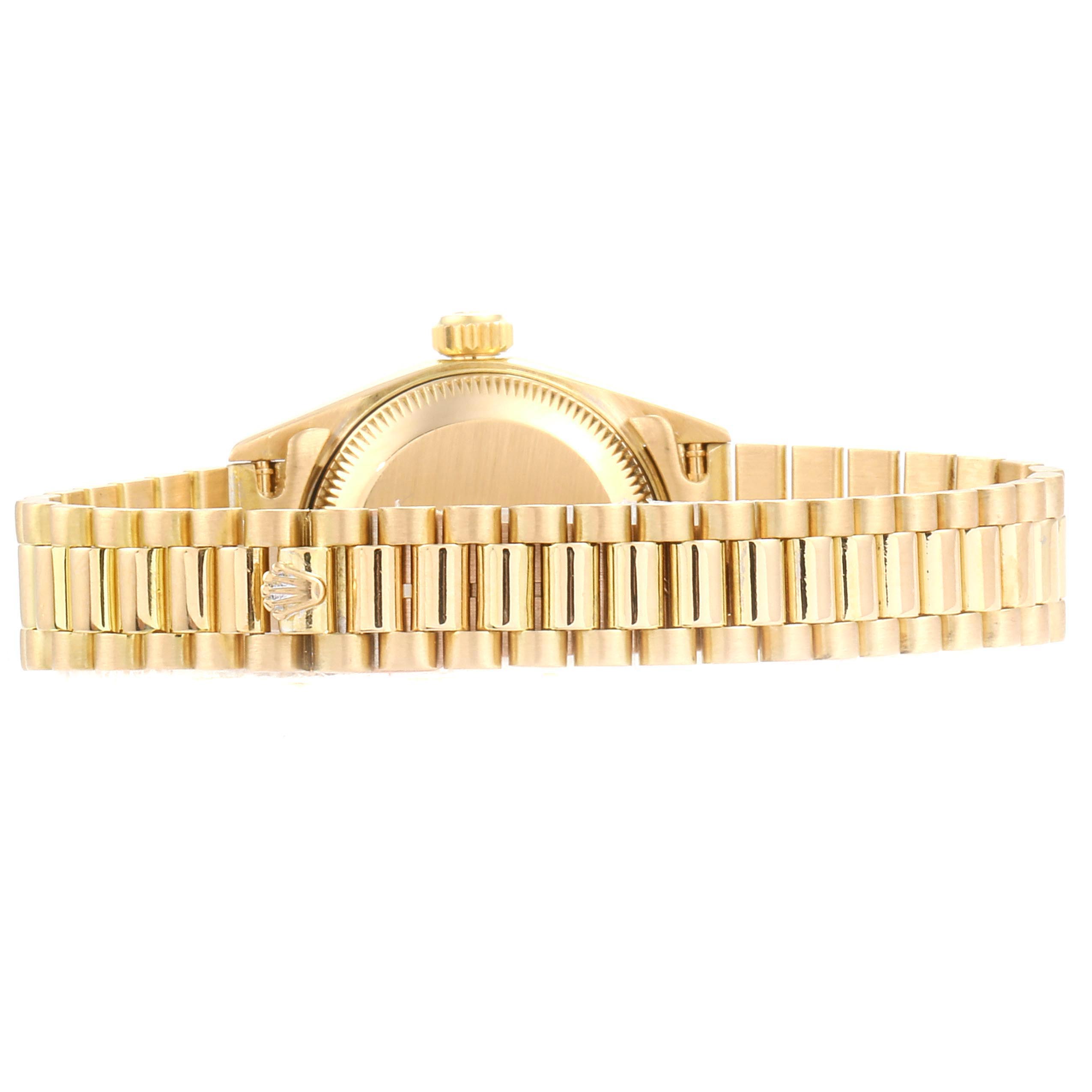 The image shows the side view of a Rolex President 69178 Women's Yellow Gold Silver Dial 69178 Women's Yellow Gold Silver Dial watch, highlighting its gold bracelet and crown.