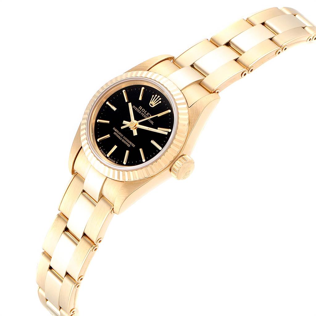 The image shows a Rolex President 67198 Women's Yellow Gold Black Dial 67198 Women's Yellow Gold Black Dial model watch at a slight angle, highlighting its gold band, black dial, and fluted bezel.