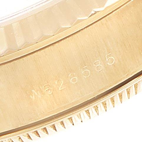 This image shows a close-up of the case and bezel of a Rolex President 67198 Women's Yellow Gold Black Dial 67198 Women's Yellow Gold Black Dial model watch, highlighting its engraved serial number.