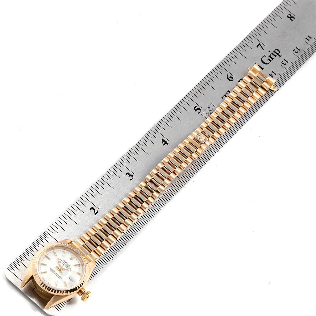 The image shows a Rolex President 69178 Women's Yellow Gold White Dial 69178 Women's Yellow Gold White Dial model watch laid flat on a ruler, focusing on the face, case, and bracelet length.