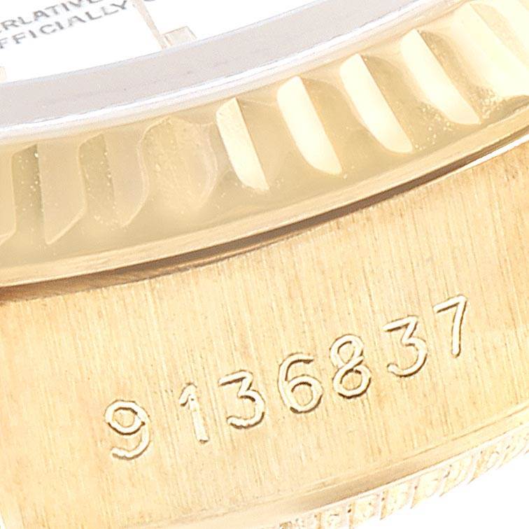 The image shows a close-up of the serial number and part of the fluted bezel of a Rolex President 69178 Women's Yellow Gold White Dial 69178 Women's Yellow Gold White Dial model watch.