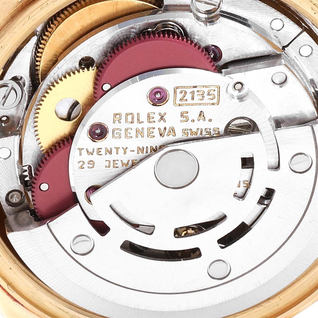 The image shows a close-up of the Rolex movement for the President model, highlighting its internal gears and components.
