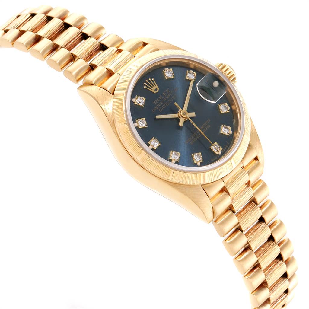 The Rolex President 69278 Women's Yellow Gold Blue Dial 69278 Women's Yellow Gold Blue Dial model watch is shown at an angled view, displaying the bracelet, case, bezel, and dial with diamond hour markers.