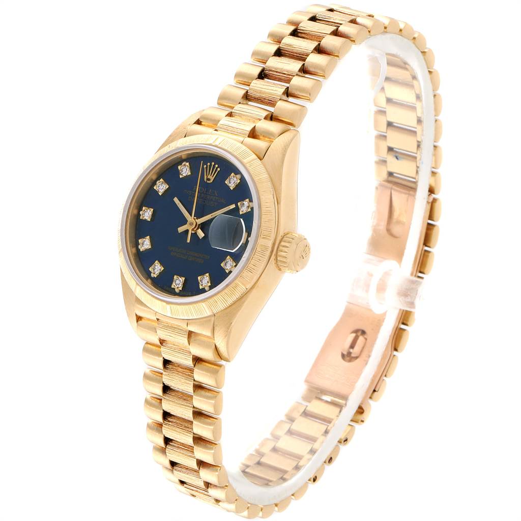 The image shows a Rolex President 69278 Women's Yellow Gold Blue Dial 69278 Women's Yellow Gold Blue Dial model watch from a three-quarter angle, highlighting the gold band, blue dial, and diamond markers.