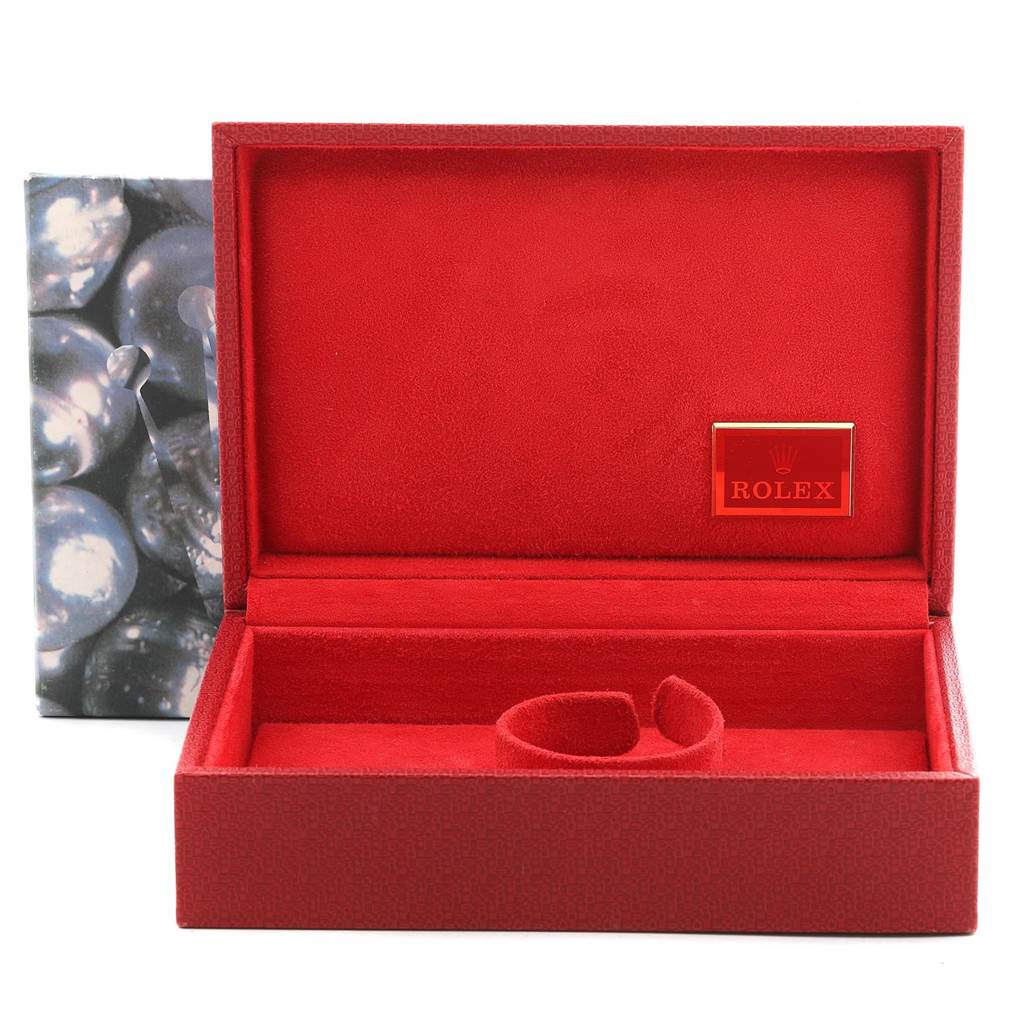 This image shows an open red Rolex box for the President model, featuring the Rolex logo inside.