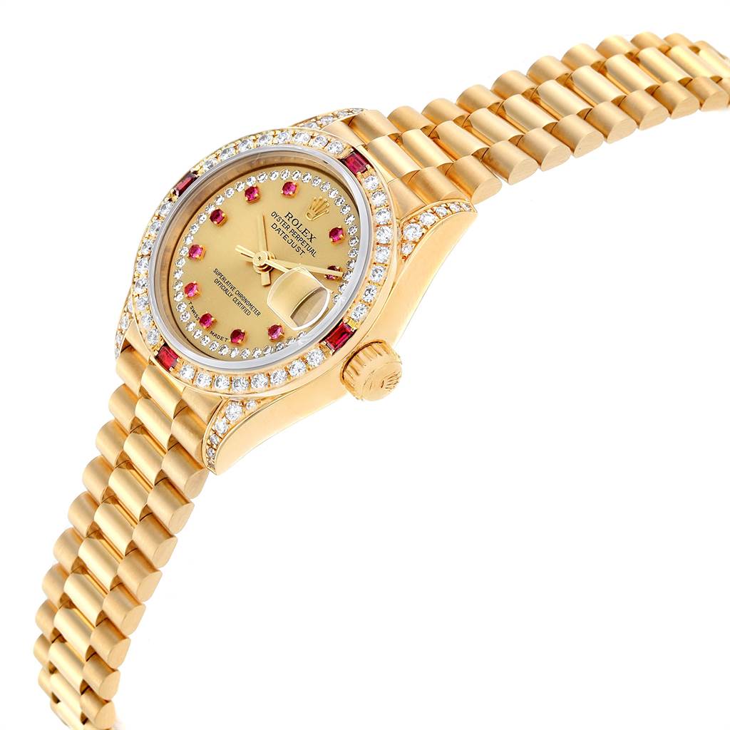 The image shows a Rolex President 69238 Women
s Yellow Gold Champagne Dial 69238 Women
s Yellow Gold Champagne Dial model watch at a tilted side angle, showcasing its gold bracelet, crown, and diamond-studded bezel.